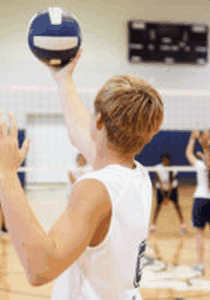 Player serving a volleyball underhand