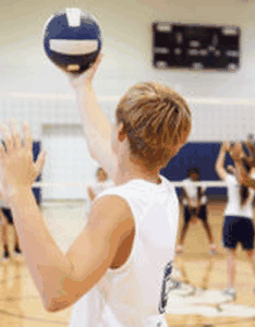 Player finishing underhand serving a volleyball